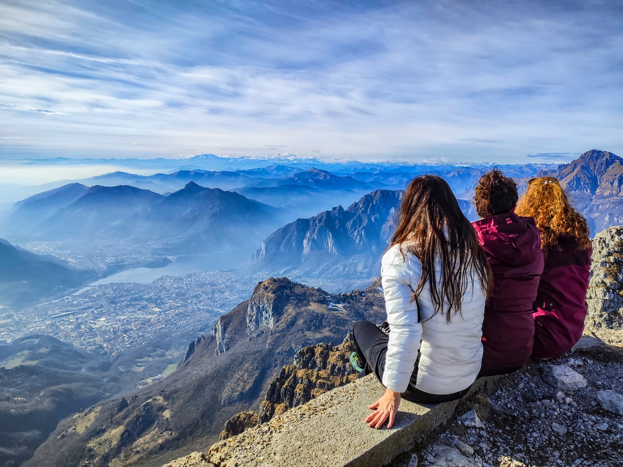 A happy group of friends hiking in the autumn forest, enjoying a sunny day and having fun conversations.